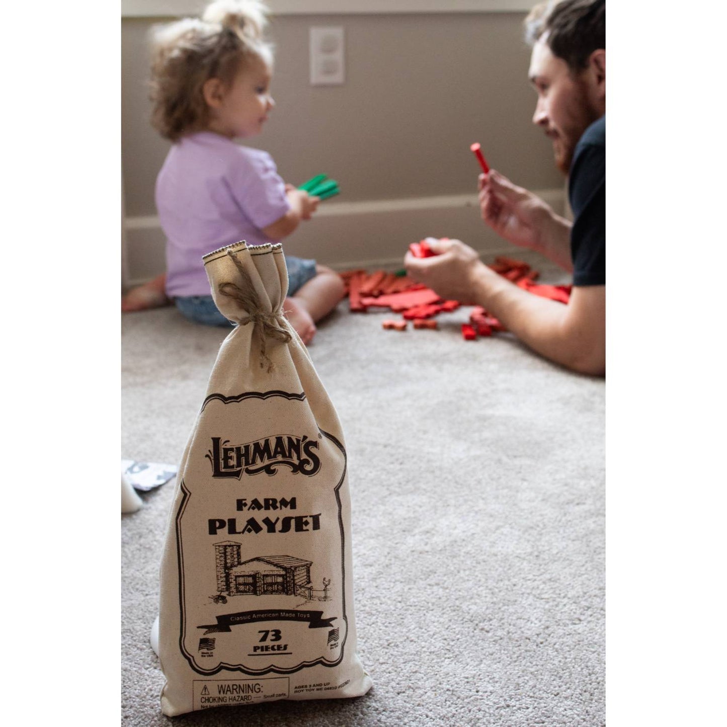 Reusable fabric bag containing a handcrafted wooden log playset with 73 pieces, made in the USA for imaginative indoor play, part of Toys, Books & Games and Wooden Toys collections.