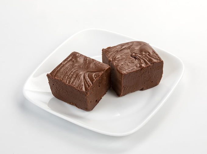 Two handcrafted rich chocolate fudge squares with a smooth, creamy texture on a white plate, featured in Kitchen & Food, Snacks and Sweets, USA Made, Best Sellers, and Promo Eligible collections.