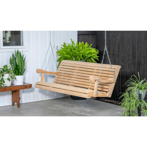 Handcrafted Amish-made 5-foot cypress hanging porch swing with smooth slatted seat and curved armrests, suspended by metal chains, surrounded by lush green plants, ideal for Home & Decor, Outdoor Furniture, USA Made, Amish Made, Best Sellers, and Promo Eligible collections.
