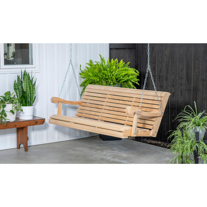 Handcrafted Amish-made 5-foot cypress hanging porch swing with smooth slatted seat and curved armrests, suspended by metal chains, surrounded by lush green plants, ideal for Home & Decor, Outdoor Furniture, USA Made, Amish Made, Best Sellers, and Promo Eligible collections.