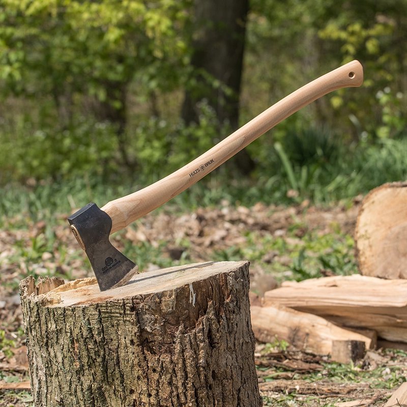 Medium-sized felling axe with a handcrafted American hickory handle and razor-sharp forged steel head, shown embedded in a tree stump outdoors, ideal for Farm, Garden & Tool and Wood Cutting collections.