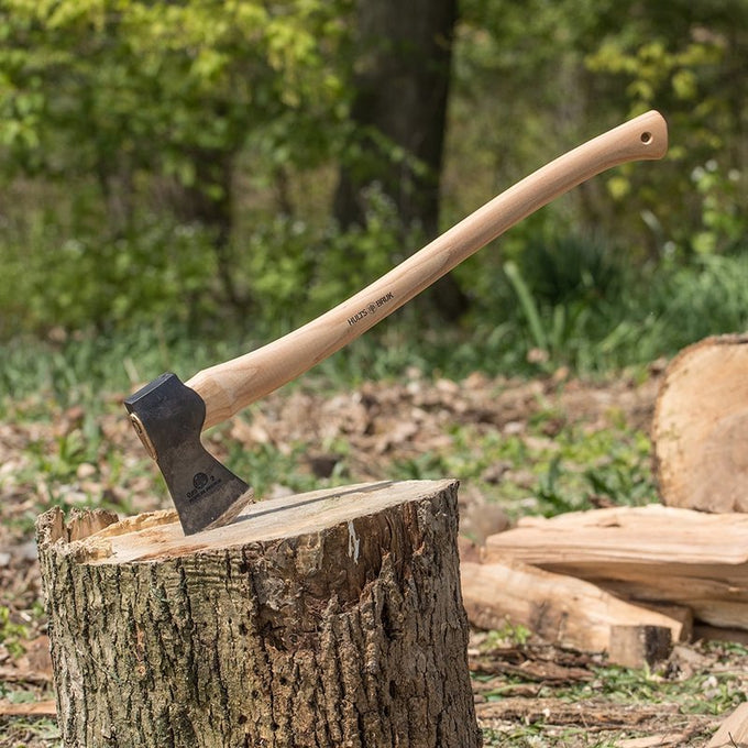 Medium-sized felling axe with a handcrafted American hickory handle and razor-sharp forged steel head, shown embedded in a tree stump outdoors, ideal for Farm, Garden & Tool and Wood Cutting collections.