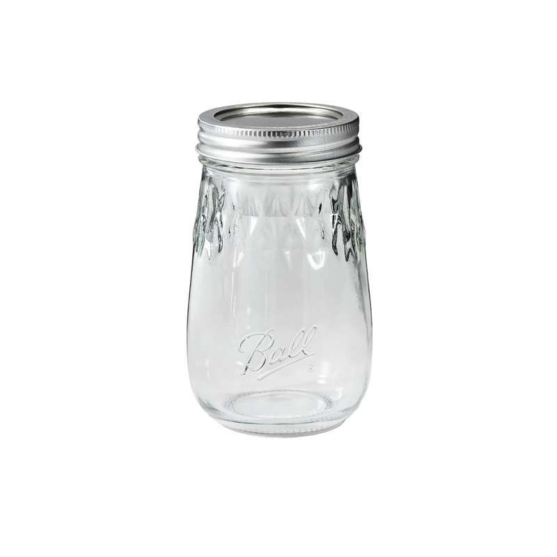 Clear regular-mouth pint canning jar with metal lid and embossed diamond pattern, crafted in the USA for kitchen food preservation and storage use.