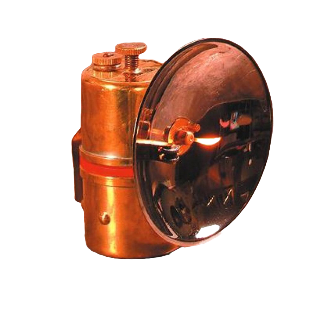 Solid brass carbide lamp with flint striker producing bright white flame, designed for durable use in camping, barn, and outdoor lighting applications.