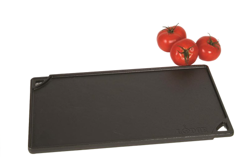 Rectangular cast iron griddle with a smooth cooking surface, corner pour spouts, and embossed logo, accompanied by fresh tomatoes, ideal for Kitchen & Food and USA Made cookware collections.