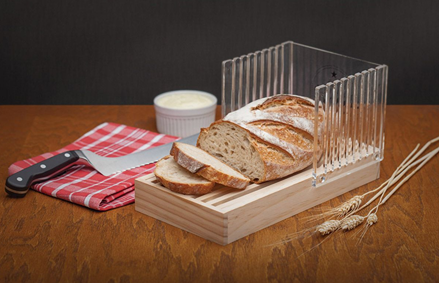 Handcrafted wooden bread slicing guide with clear acrylic panels for precise, even slices, featuring a removable crumb tray, displayed with a serrated knife and sliced artisan bread, ideal for Kitchen & Food, Kitchen Gadgets, Cooking and Baking Helpers, Storage and Serving, Best Sellers, Bread Making Supplies, and Promo Eligible collections.