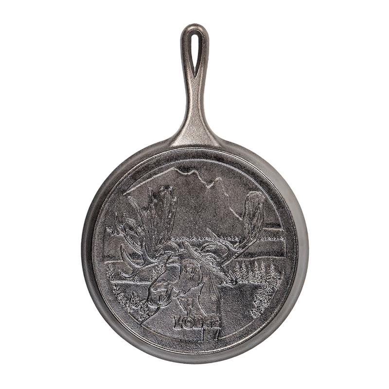 Cast iron griddle with detailed moose design and scenic Northwoods background, handcrafted in the USA, ideal for Kitchen & Food, Cookware, Cast Iron, and Best Sellers collections.