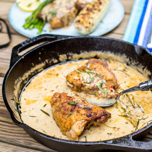Round cast iron pan with short handles cooking seared chicken in creamy herb sauce, surrounded by fresh rosemary, featured in Kitchen & Food, Cookware, Cast Iron, Best Sellers, Promo Eligible collections.