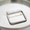 Close-up of a sturdy stainless steel handle attached to the seamless lid of a small milk can, crafted from durable 304 grade steel for use in farm, garden, and animal care settings.