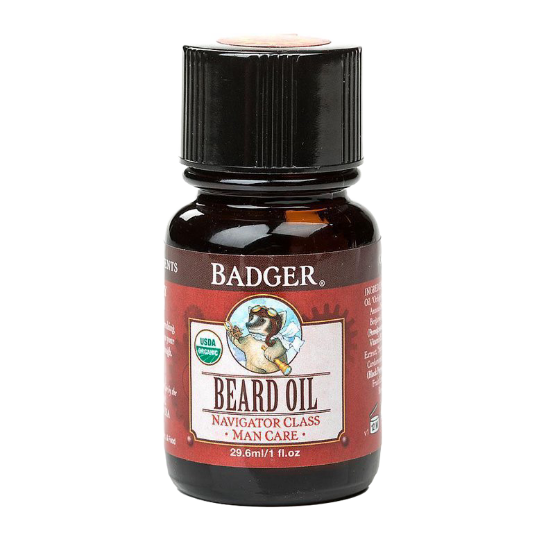 Dark amber glass bottle with black cap containing handcrafted beard oil, featuring an illustrated badger logo and red label, made in USA for grooming and personal care.
