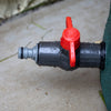 Close-up of a durable plastic spigot with a bright red handle attached to a garden water barrel, featured in Farm, Garden & Tool, Garden Accessories, Lawncare, Best Sellers, and Promo Eligible collections.