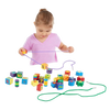 Young child playing with colorful handcrafted wooden lacing beads in various shapes and numbers, designed to support fine motor skills and indoor play in children's toy collections.