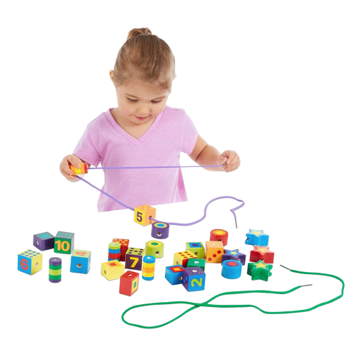 Young child playing with colorful handcrafted wooden lacing beads in various shapes and numbers, designed to support fine motor skills and indoor play in children's toy collections.