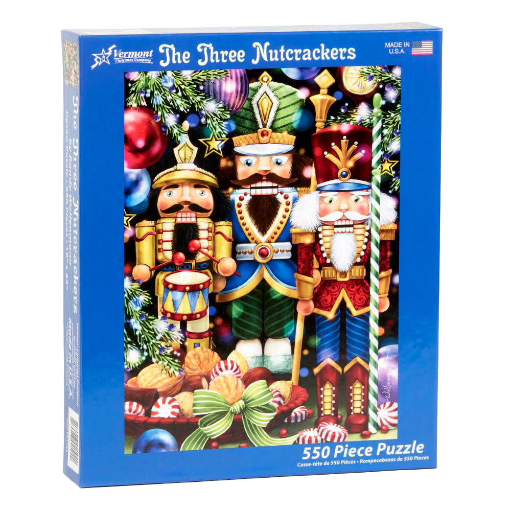 Blue box featuring a colorful holiday-themed puzzle of three detailed nutcrackers surrounded by ornaments and festive decorations, handcrafted and made in USA, ideal for Toys, Books & Games, Games and Puzzles, Puzzles, Best Sellers, and Promo Eligible collections.