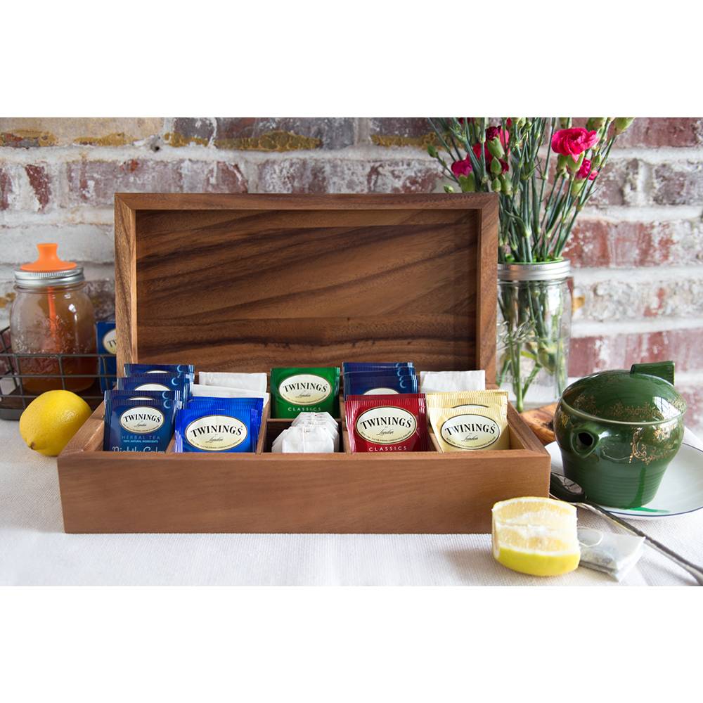 Handcrafted acacia wood double tea box with ten compartments holding assorted tea bags, shown open on a white surface with a lemon wedge, green teapot, and fresh flowers in Kitchen & Food and Brewing Coffee and Tea collections.