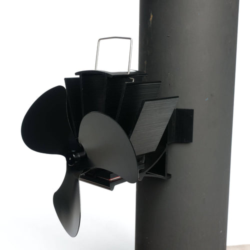 Black three-bladed magnetic stove fan mounted on a flue pipe with metal fins for heat-powered air circulation, featured in Stoves, Hearth Accessories, Best Sellers, and Promo Eligible collections.