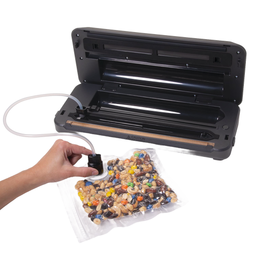 Black automatic vacuum sealer with integrated bag cutter sealing a clear bag of mixed nuts and candy, ideal for Kitchen & Food, Food Preservation, Freezing, and Best Sellers collections.