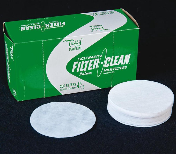 Stack of handcrafted white filter disks for milk strainers placed beside green and white packaging box, featured in Farm, Garden & Tool and Animal Care collections.