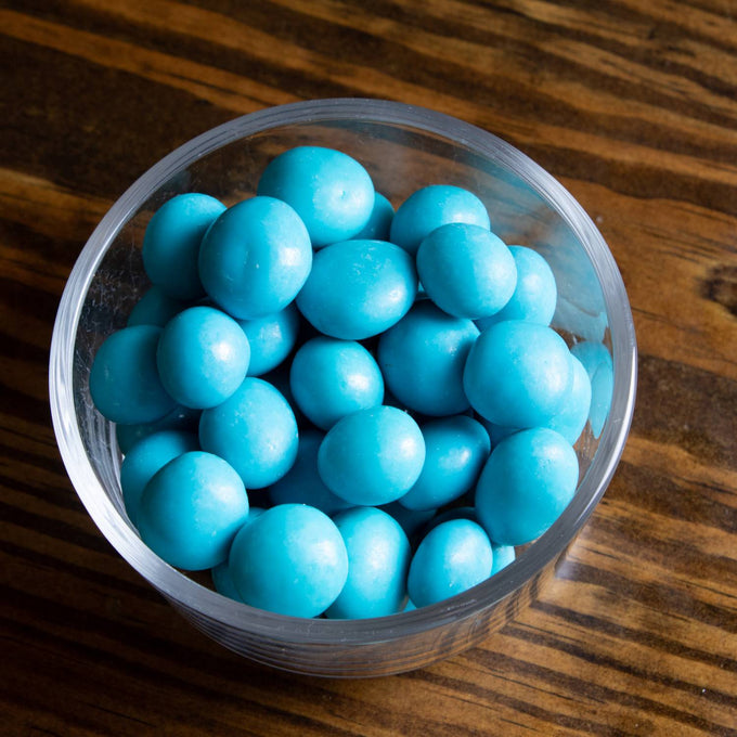 Clear bowl filled with handcrafted chocolate-covered blueberries coated in bright blue, made in USA, ideal for Kitchen & Food, Snacks and Sweets, Candy, and Best Sellers collections.