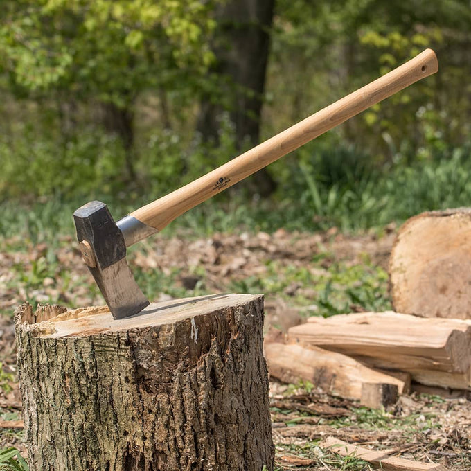 Handcrafted splitting maul with wooden handle embedded in a tree stump outdoors, ideal for wood cutting and hauling, featured in Farm, Garden & Tool and Best Sellers collections.
