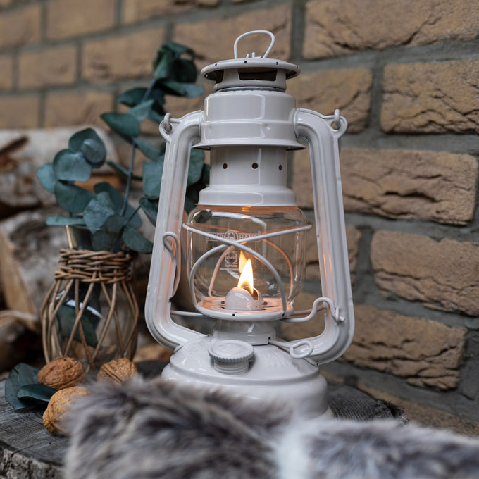 Handcrafted light gray galvanized lantern with thermal heat-resistant globe lit softly on a wooden surface near rustic decor, perfect for Lamps & Lighting, Camping, and Emergency Supplies collections.
