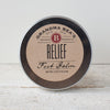 Round metal tin of handcrafted natural relief foot balm with simple kraft paper label, made in USA, featured in Health & Wellness, Balms, Creams and Lotions, and Best Sellers collections.