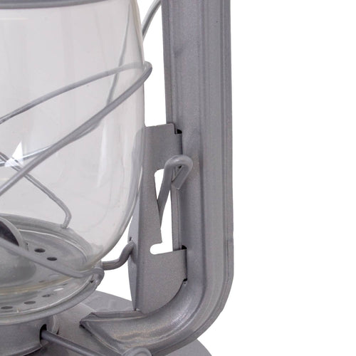 Close-up of a handcrafted metal frame and clear glass globe on a durable lantern designed for dependable lighting in farm, garden, camping, and emergency use.