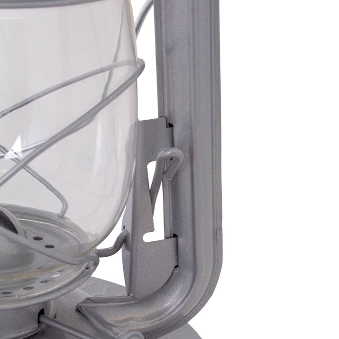 Close-up of a handcrafted metal frame and clear glass globe on a durable lantern designed for dependable lighting in farm, garden, camping, and emergency use.