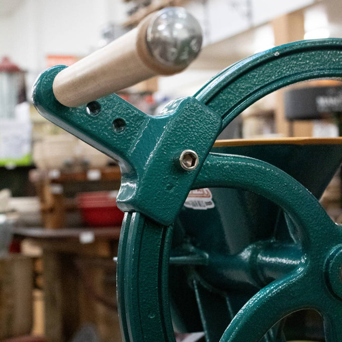 Green cast iron handle extension with a smooth wooden grip, designed to improve leverage for easier grain milling, ideal for Kitchen & Food, Grain Mills, and Bread Making Supplies collections.