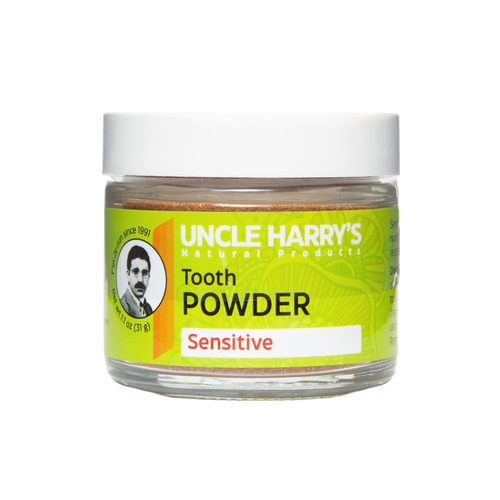 Clear jar of handcrafted Uncle Harry's natural tooth powder for sensitive teeth, featuring a bright green label with warming essential oils, ideal for health remedies and personal hygiene.