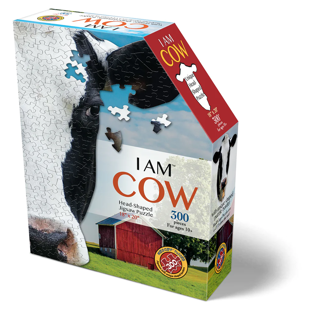 Box for a handcrafted, cow head-shaped 300-piece jigsaw puzzle featuring a close-up cow image and a barn scene, part of toys and games collections for ages 10 and up.