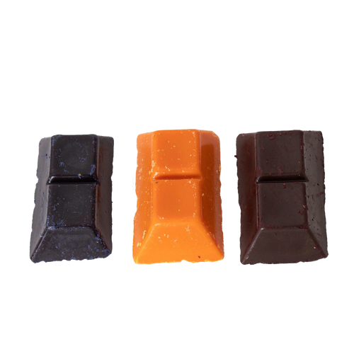 Three handcrafted soy wax dye chips in red, yellow, and dark brown colors, designed for use in candles and candlemaking, candlemaking supplies, and best sellers collections.