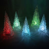 Set of five indoor acrylic trees with textured surfaces illuminated by changing multicolored LED lights in red, blue, green, and purple, perfect for Home & Decor and Holiday Decor collections.