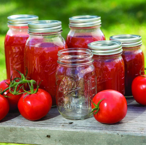 Clear glass canning jars with metal lids filled with homemade tomato sauce, surrounded by fresh tomatoes, showcasing durable jars ideal for Kitchen & Food, Food Preservation, Canning, USA Made, and Best Sellers collections.