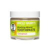 Small glass jar of handcrafted alkalizing mineral toothpaste in cinnamon flavor with a bright yellow label, promoting natural health and wellness and American-made grooming care.