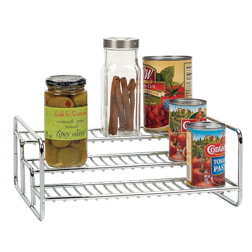 Chrome-finished 3-tier rack holding assorted pantry items including a jar of olives, a spice container with cinnamon sticks, and several canned goods, ideal for kitchen organization and storage.