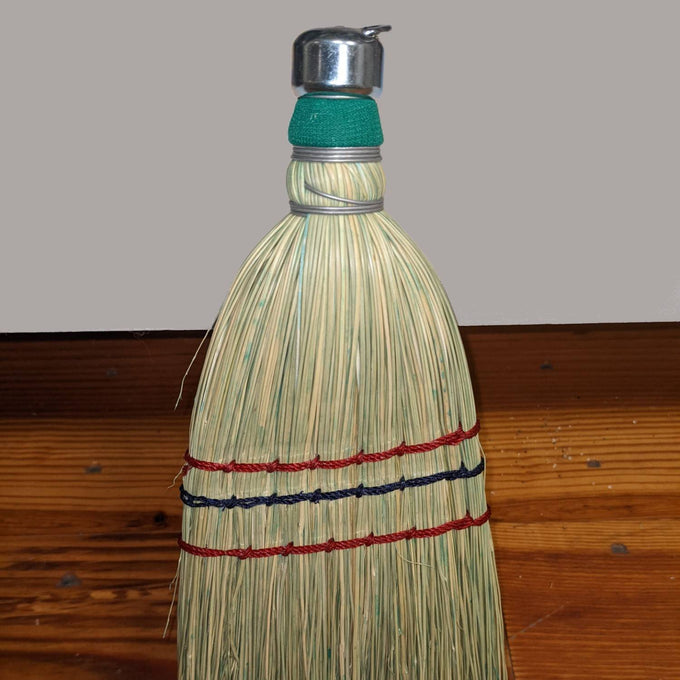 Handcrafted corn whisk broom made in the USA with tightly bound natural corn straw and metal cap, featuring colorful stitched bands, ideal for household cleaning in Home & Decor and Cleaning Utensils collections.