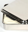 Close-up of a handcrafted stainless steel cake pan with a partially open lid showing a white creamy dessert inside, ideal for holiday hosting and baking supplies.