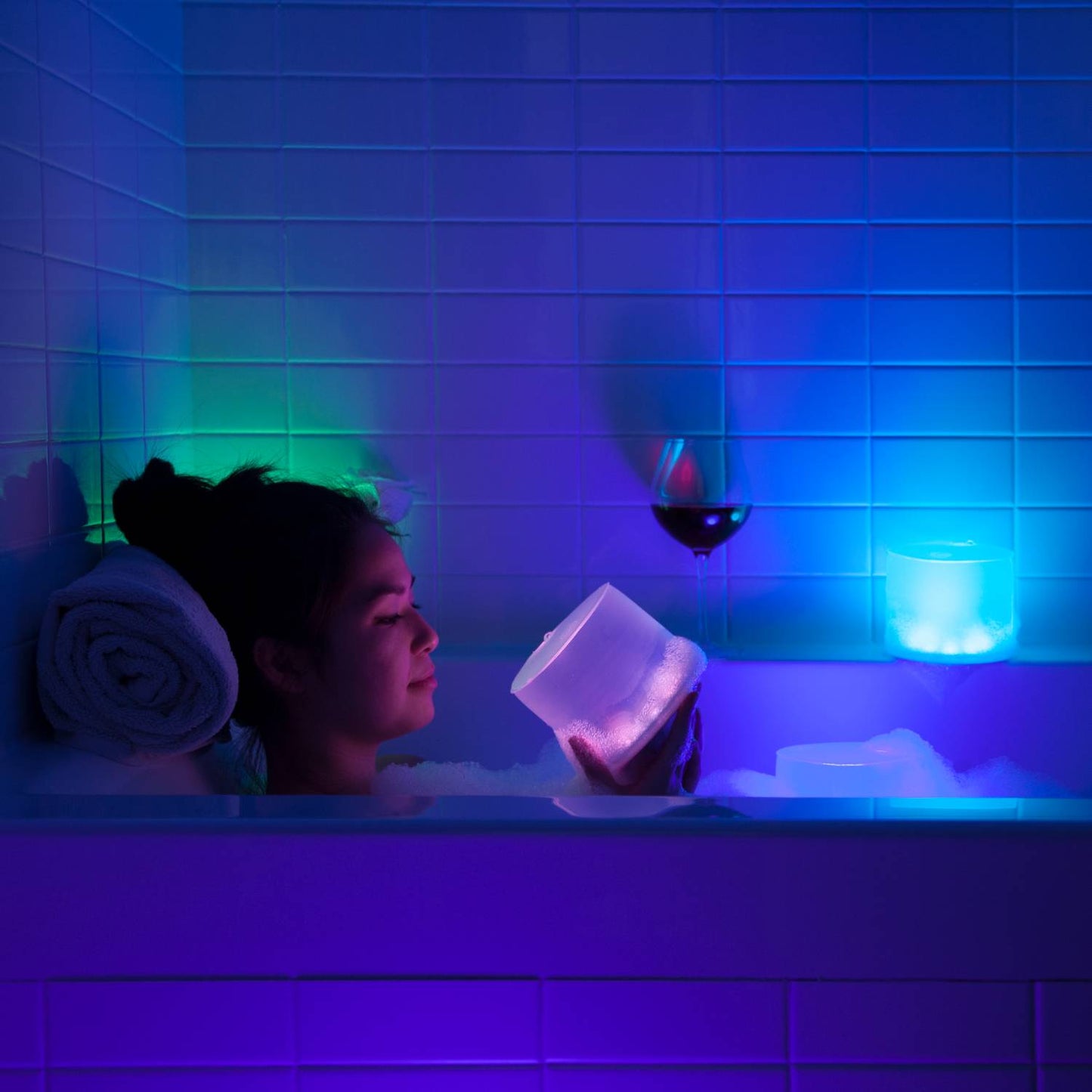 Handcrafted Luci Color Essence solar light glowing softly with shifting colors, creating a relaxing ambiance in a bathtub setting, ideal for Lamps & Lighting and cozy indoor use.