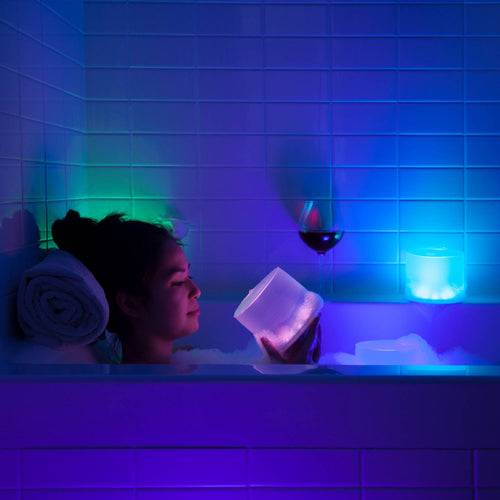 Handcrafted Luci Color Essence solar light glowing softly with shifting colors, creating a relaxing ambiance in a bathtub setting, ideal for Lamps & Lighting and cozy indoor use.