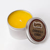 Open tin containing bright yellow handcrafted citronella candle, ideal for camping and outdoor pest control, featured in Farm, Garden & Tool and Camping collections.