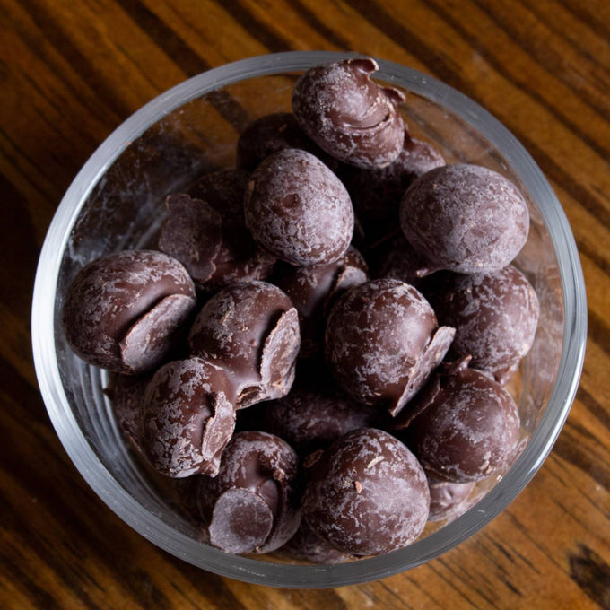 Clear glass bowl filled with handcrafted double dipped chocolate peanuts coated with fresh roasted nuts, a unique snack from USA made Kitchen & Food, Snacks and Sweets, Candy, Best Sellers, and Promo Eligible collections.