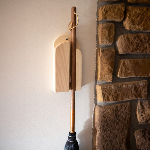 Handcrafted Amish made wooden wall broom holder mounted beside a rustic stone wall, designed for organized storage in Home & Decor, Household Helpers, and Cleaning Utensils collections.