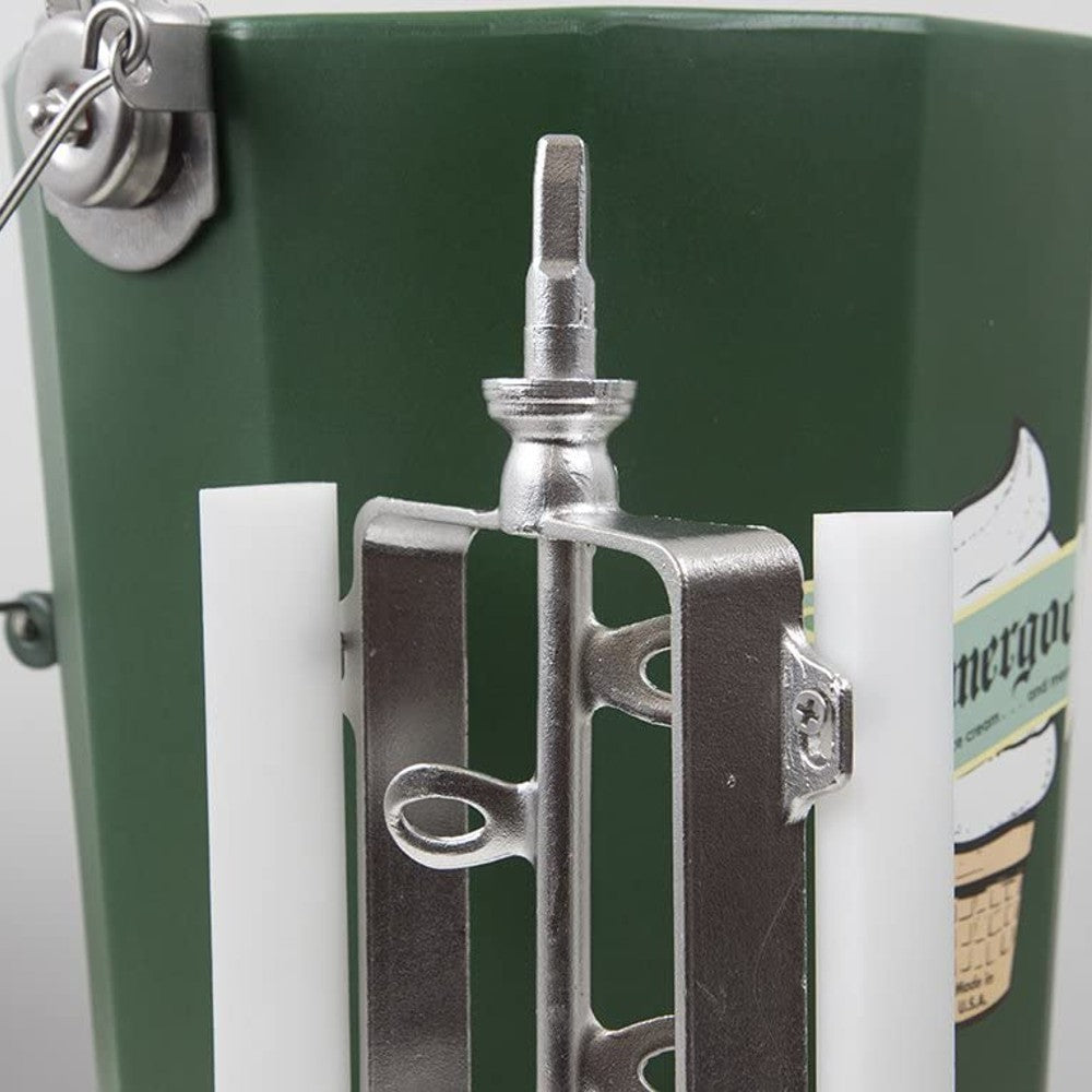 Close-up view of a polished stainless steel freezing paddle assembly with white plastic blades attached to the hand-crank mechanism on a handcrafted green Amish-made ice cream freezer bucket, part of kitchen and specialty food equipment collections.