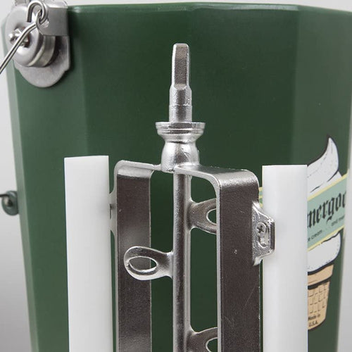 Close-up view of a polished stainless steel freezing paddle assembly with white plastic blades attached to the hand-crank mechanism on a handcrafted green Amish-made ice cream freezer bucket, part of kitchen and specialty food equipment collections.