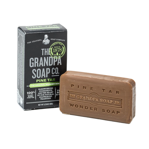 Bar of pine tar soap with embossed branding beside its black and green box, handcrafted and made in USA, featured in Health & Wellness, Grooming and Personal Hygiene, and Best Sellers collections.