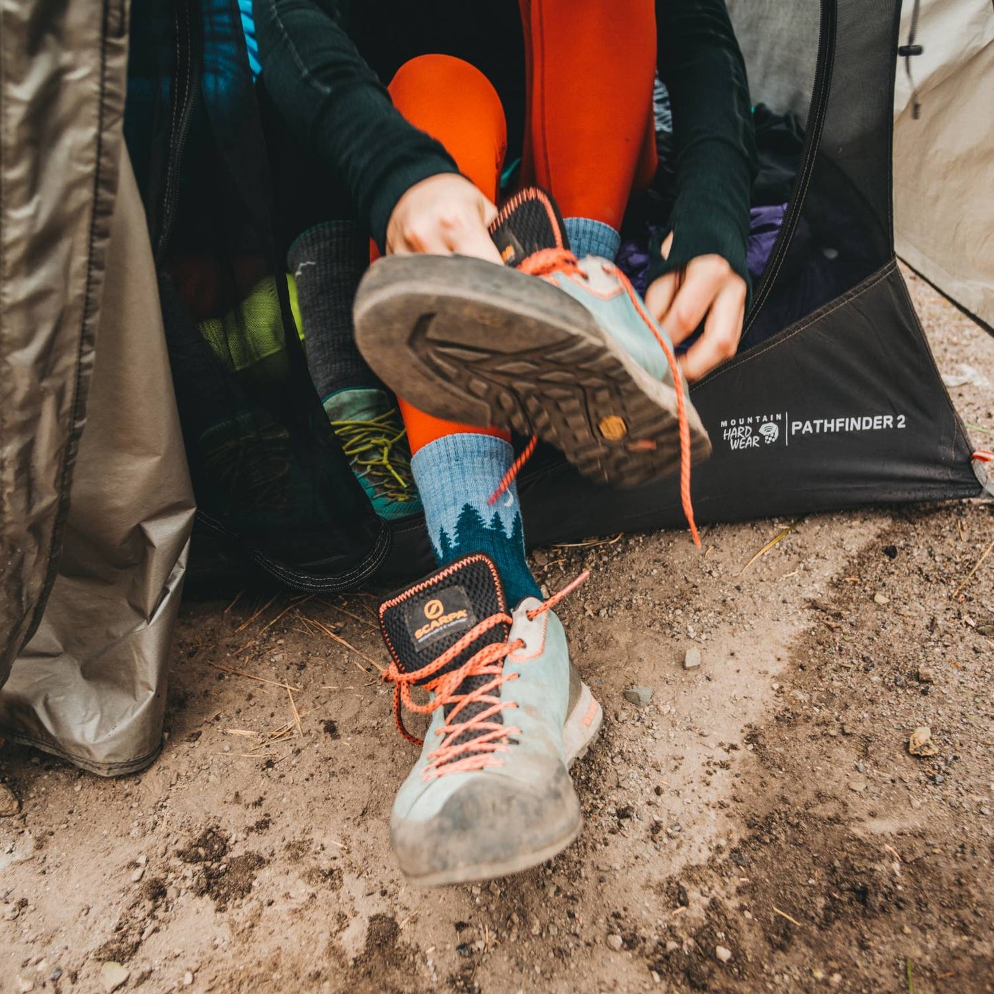 Close-up of women's hiking boots with cushioned midweight crew socks featuring a treeline pattern, handcrafted and made in USA, ideal for camping, health & wellness, and outdoor collections.