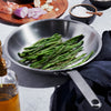 Handcrafted stainless steel fry pan with fully clad 5-ply construction cooking sautéed green beans, featured in Kitchen & Food, Cookware, Pots and Pans, Best Sellers, Promo Eligible collections.
