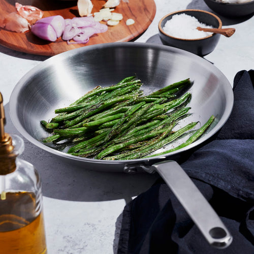 Handcrafted stainless steel fry pan with fully clad 5-ply construction cooking sautéed green beans, featured in Kitchen & Food, Cookware, Pots and Pans, Best Sellers, Promo Eligible collections.