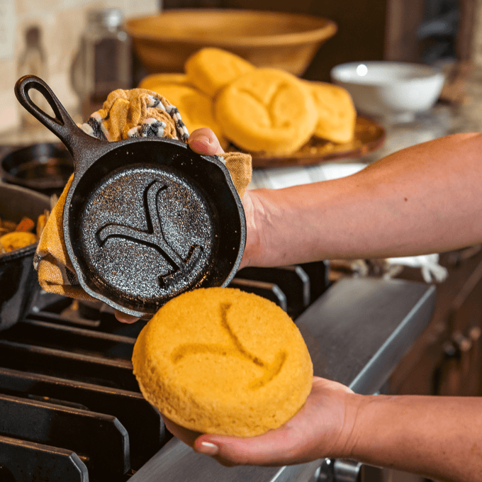 Handcrafted cast iron skillet with a distinctive embossed "Y" design, freshly used to make cornbread, highlighting USA Made cookware for Kitchen & Food and Best Sellers collections.